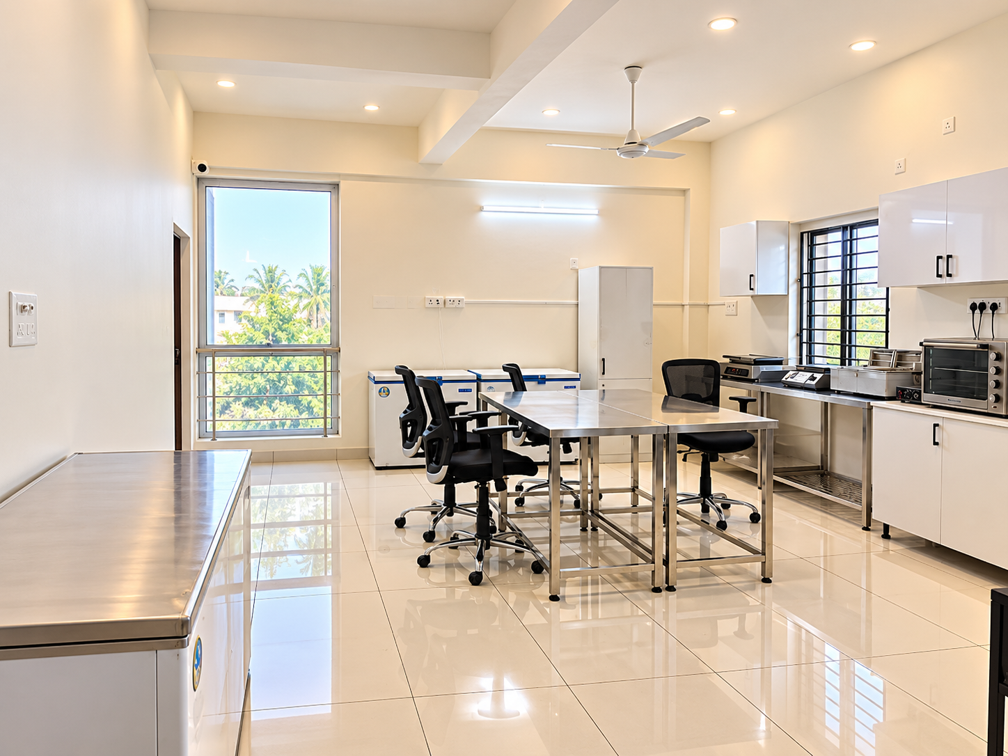 Fine Dine Academy training kitchen with steel tables, chairs, freezers and storage