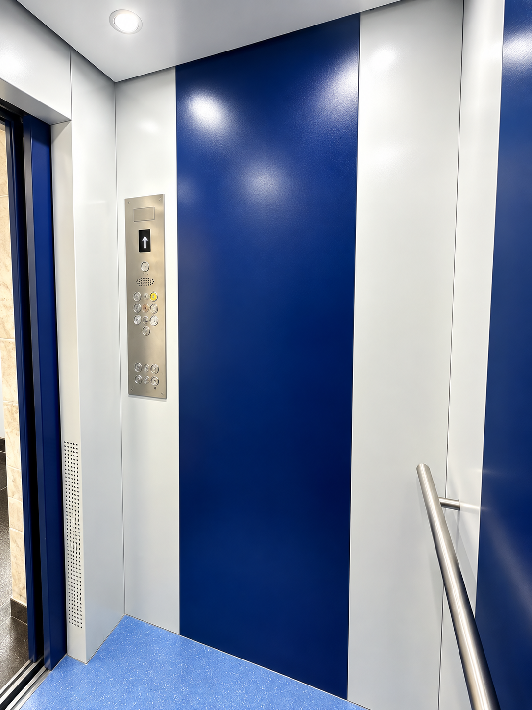 Fine Dine Academy lift cabin control panel with floor buttons and handrail